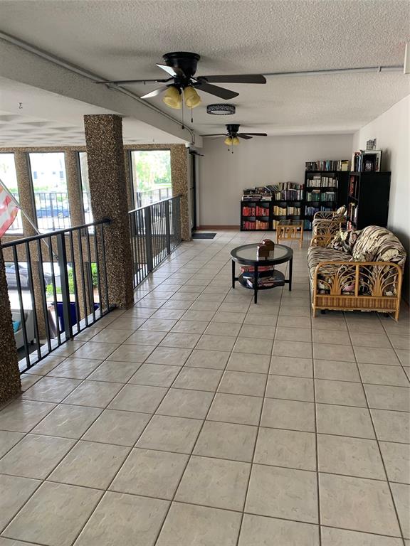 9355 Southwest 8th Street, Unit 321 Boca Raton, FL 33428 - Photo 14 of 15 a living room with furniture and a flat screen tv