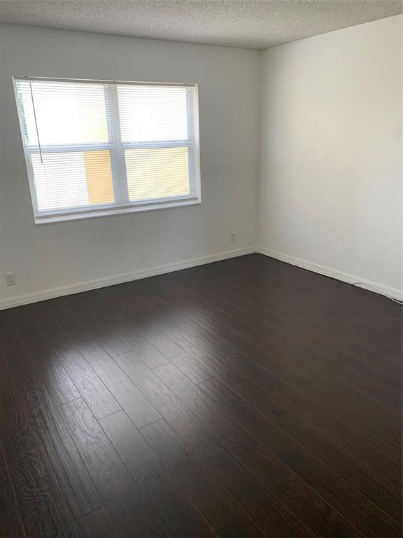 9355 Southwest 8th Street, Unit 321 Boca Raton, FL 33428 - Photo 6 of 15 an empty room with wooden floor and windows