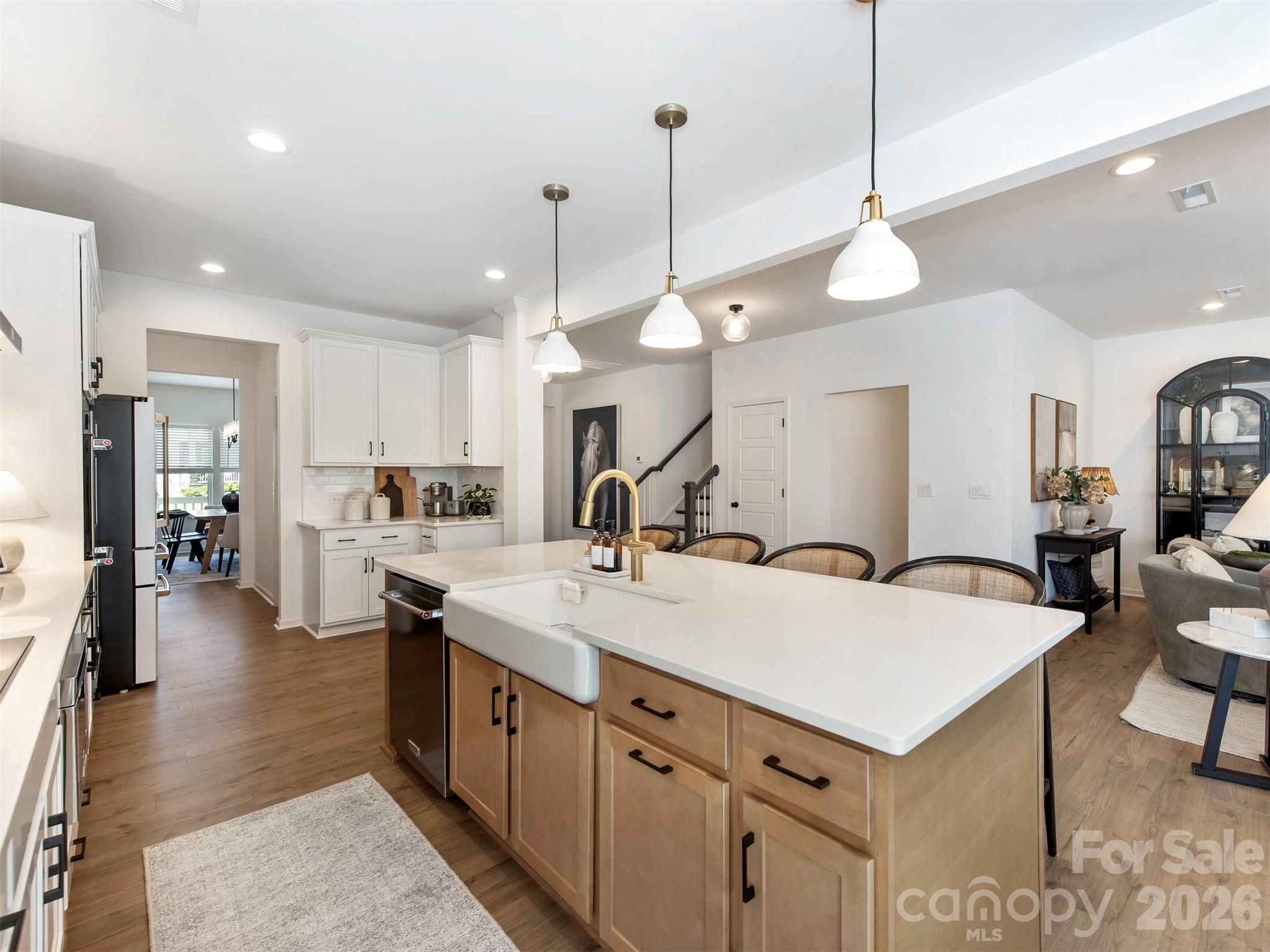 966 Scotch Meadows Loop Monroe, NC 28110 - Photo 13 of 48 a large kitchen with kitchen island a large island a sink stainless steel appliances and cabinets