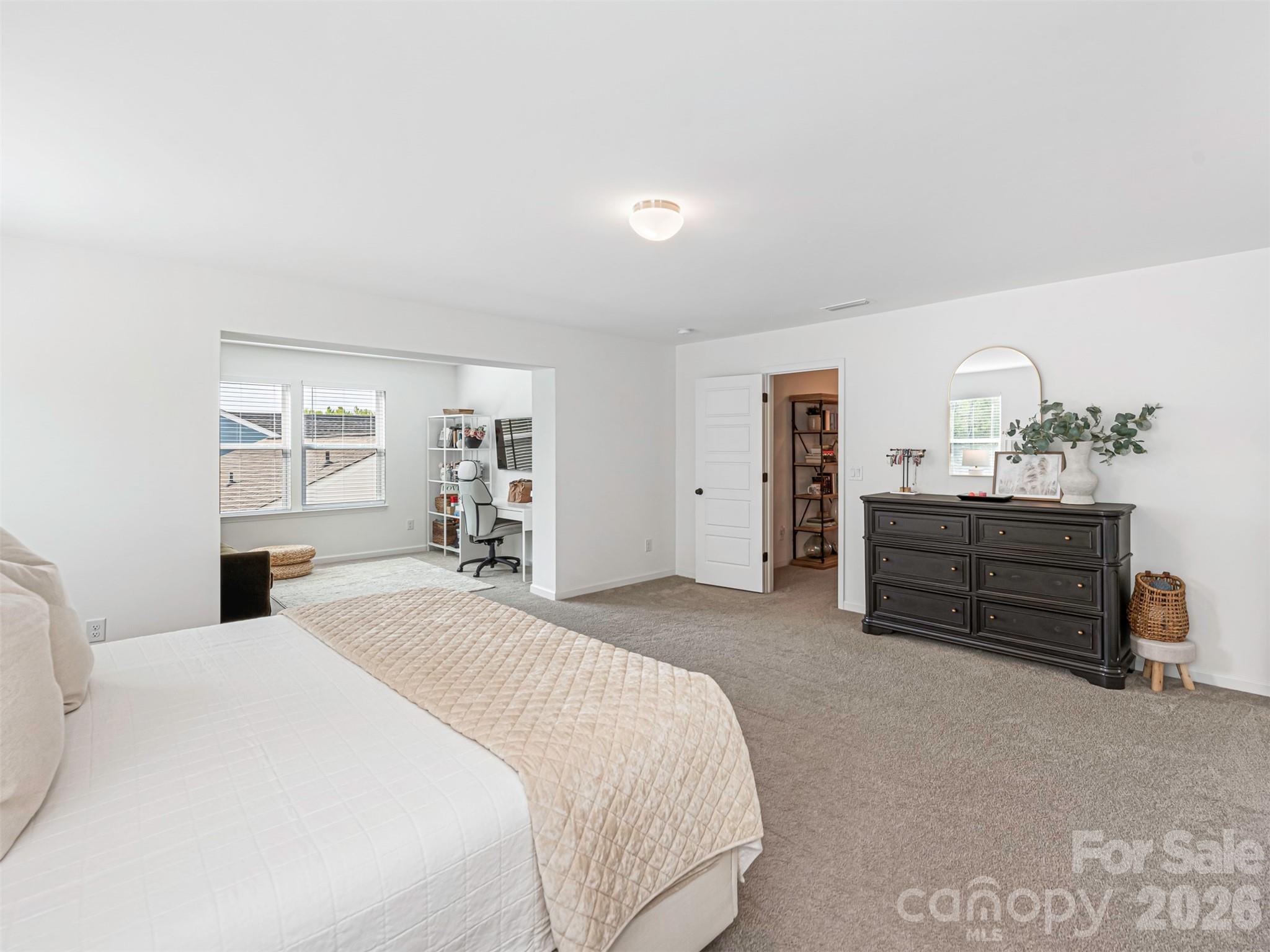 966 Scotch Meadows Loop Monroe, NC 28110 - Photo 21 of 48 a spacious bedroom with a bed and a cabinets