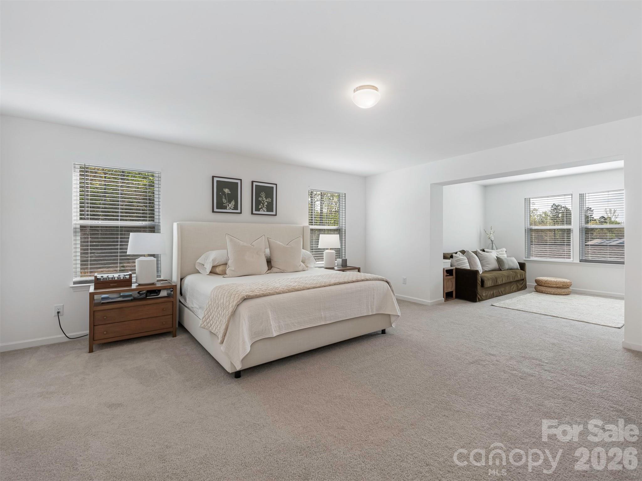 966 Scotch Meadows Loop Monroe, NC 28110 - Photo 22 of 48 a spacious bedroom with a bed and a couch