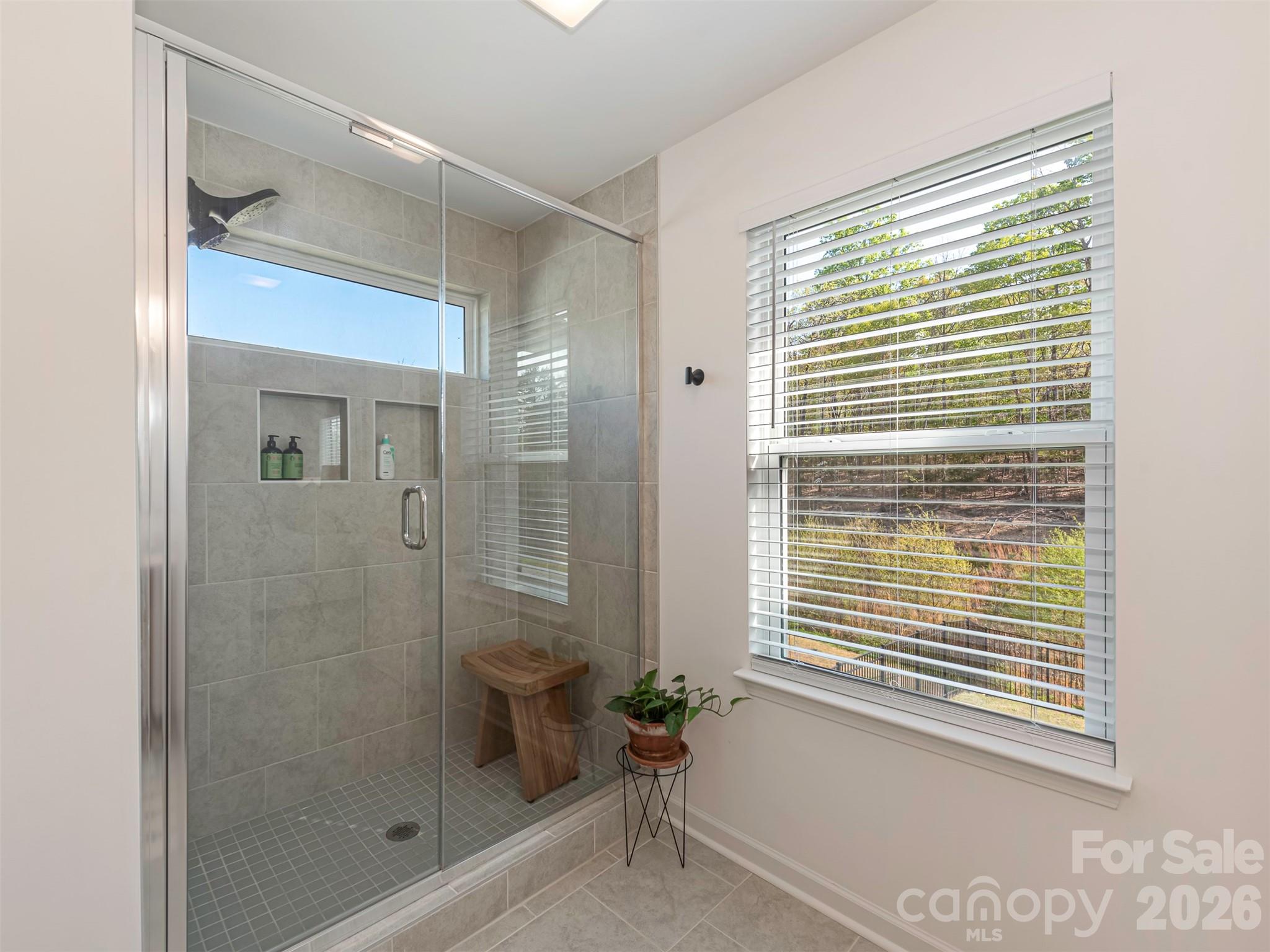 966 Scotch Meadows Loop Monroe, NC 28110 - Photo 26 of 48 a bathroom with a shower and a window