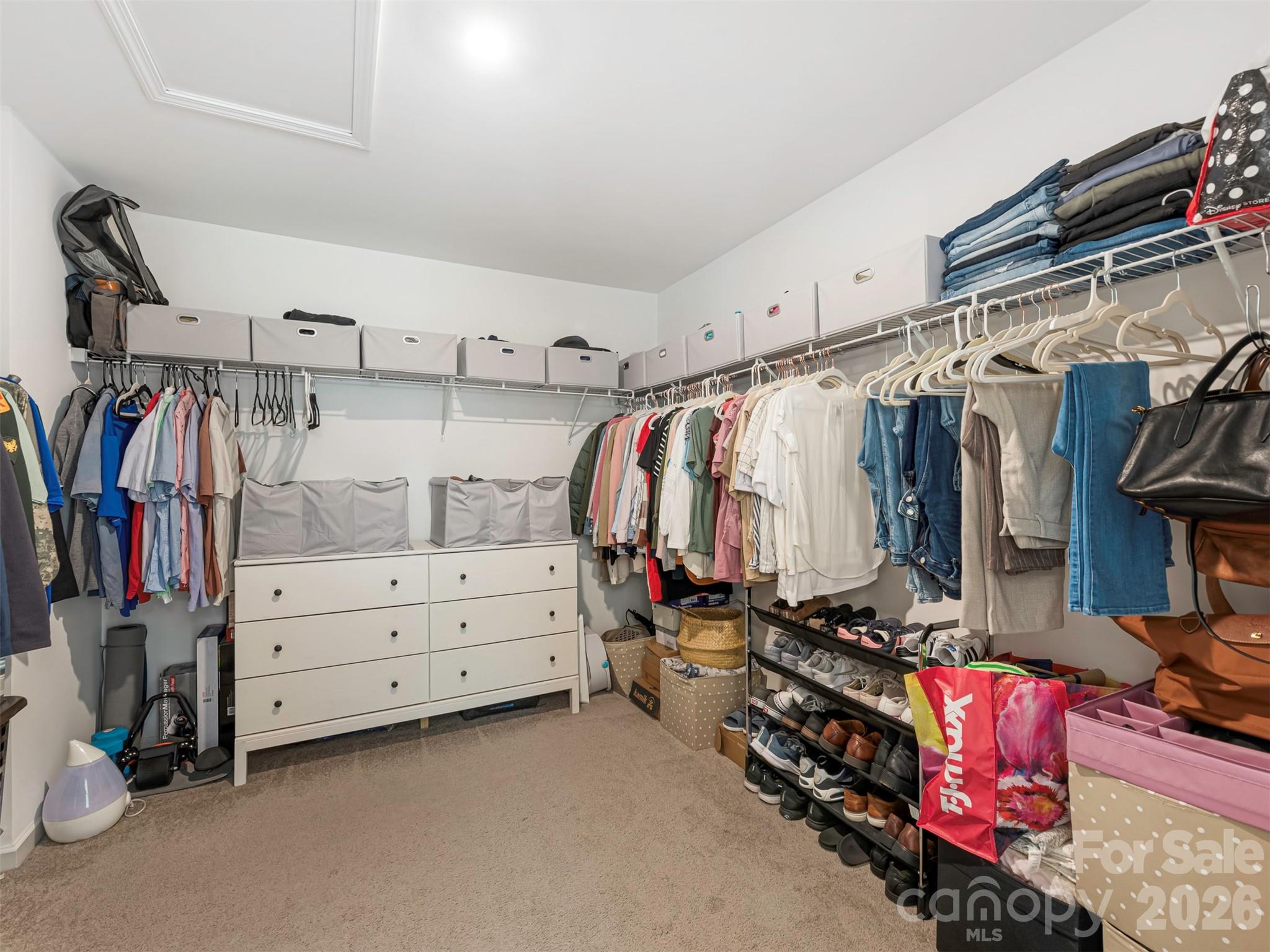 966 Scotch Meadows Loop Monroe, NC 28110 - Photo 27 of 48 a view of walk in closet with clothes and shoes