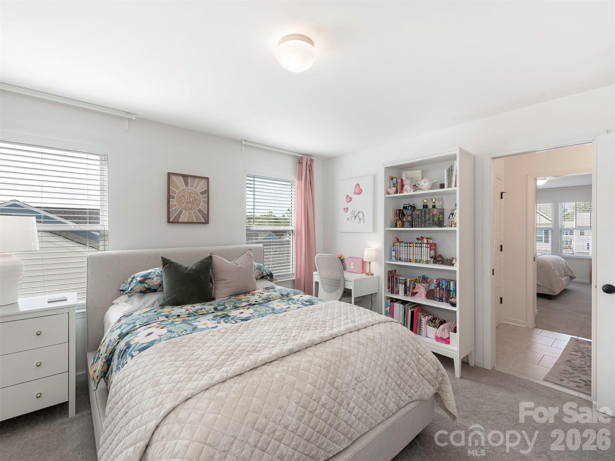 966 Scotch Meadows Loop Monroe, NC 28110 - Photo 29 of 48 a bedroom with a large bed and a book shelf