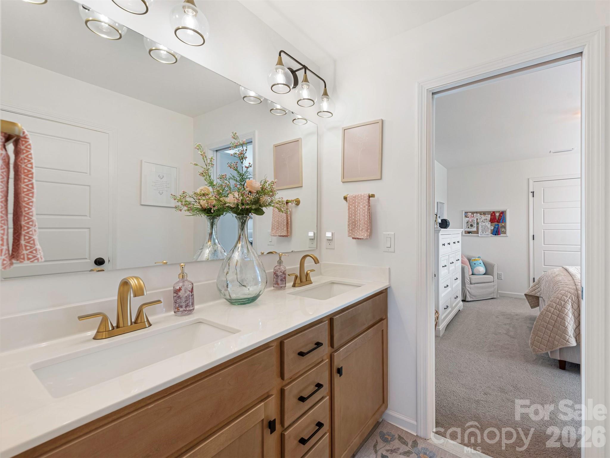 966 Scotch Meadows Loop Monroe, NC 28110 - Photo 30 of 48 a bathroom with a sink a vanity and a mirror