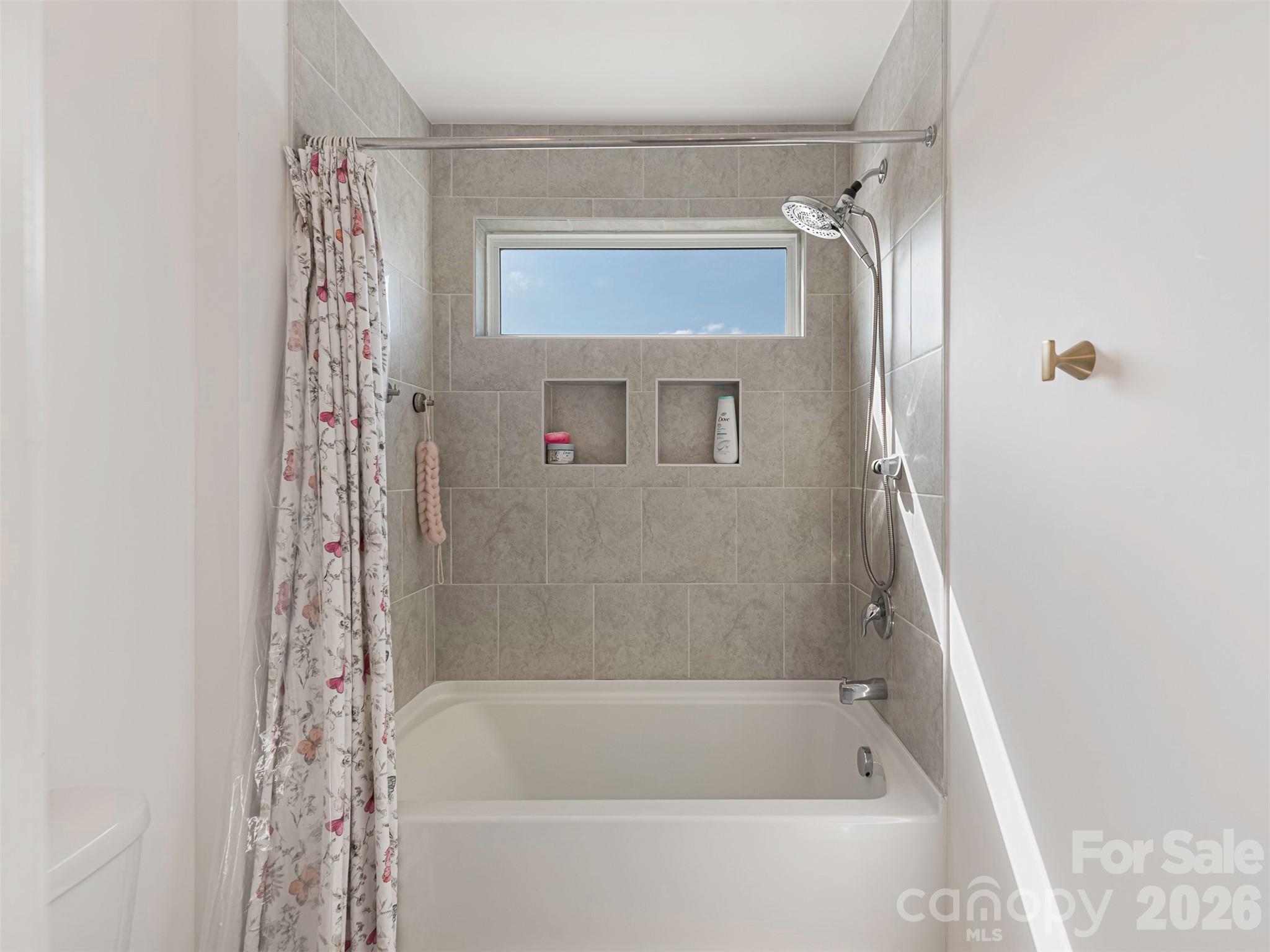 966 Scotch Meadows Loop Monroe, NC 28110 - Photo 31 of 48 a bathroom with a bathtub and a shower