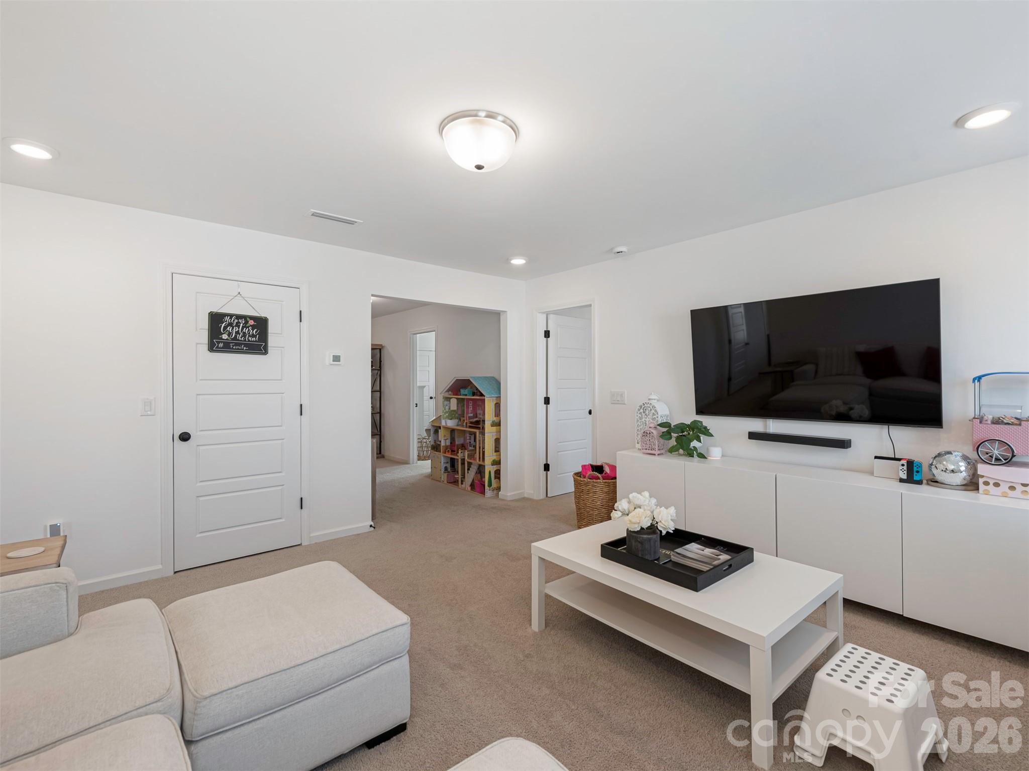 966 Scotch Meadows Loop Monroe, NC 28110 - Photo 36 of 48 a living room with furniture and a flat screen tv
