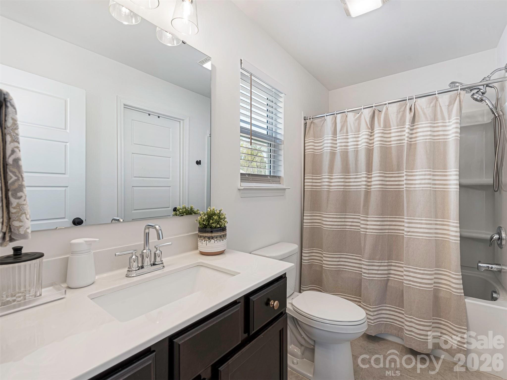 966 Scotch Meadows Loop Monroe, NC 28110 - Photo 39 of 48 a bathroom with a sink toilet and shower