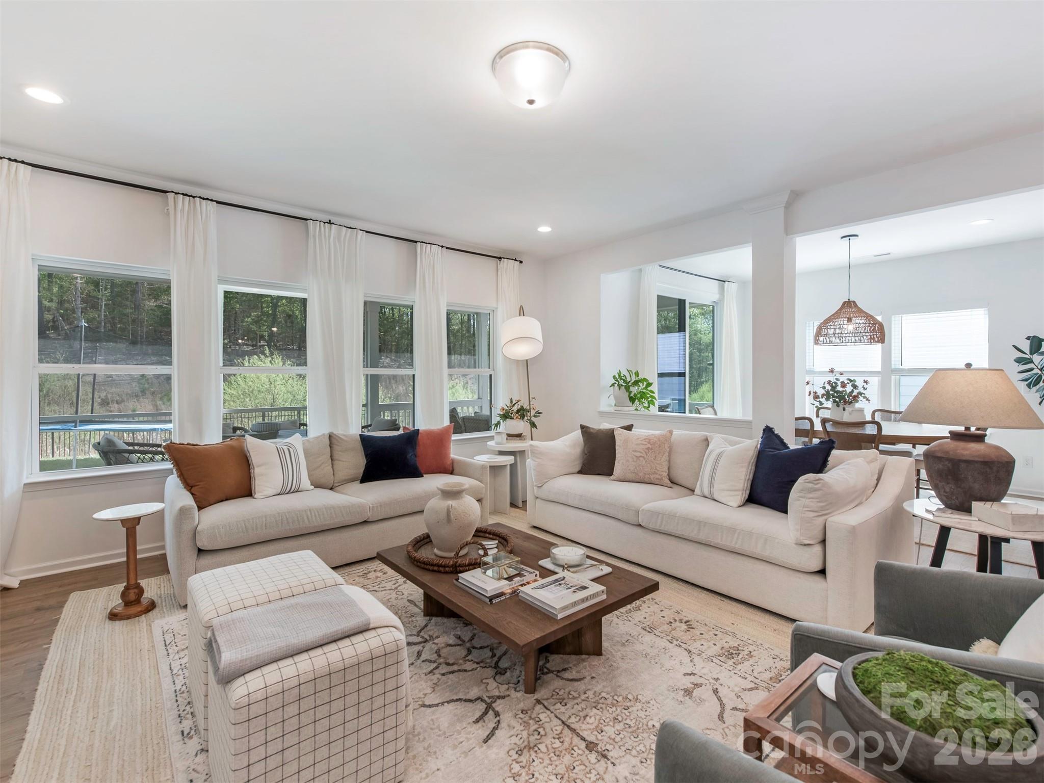 966 Scotch Meadows Loop Monroe, NC 28110 - Photo 7 of 48 a living room with furniture potted plant and a large window