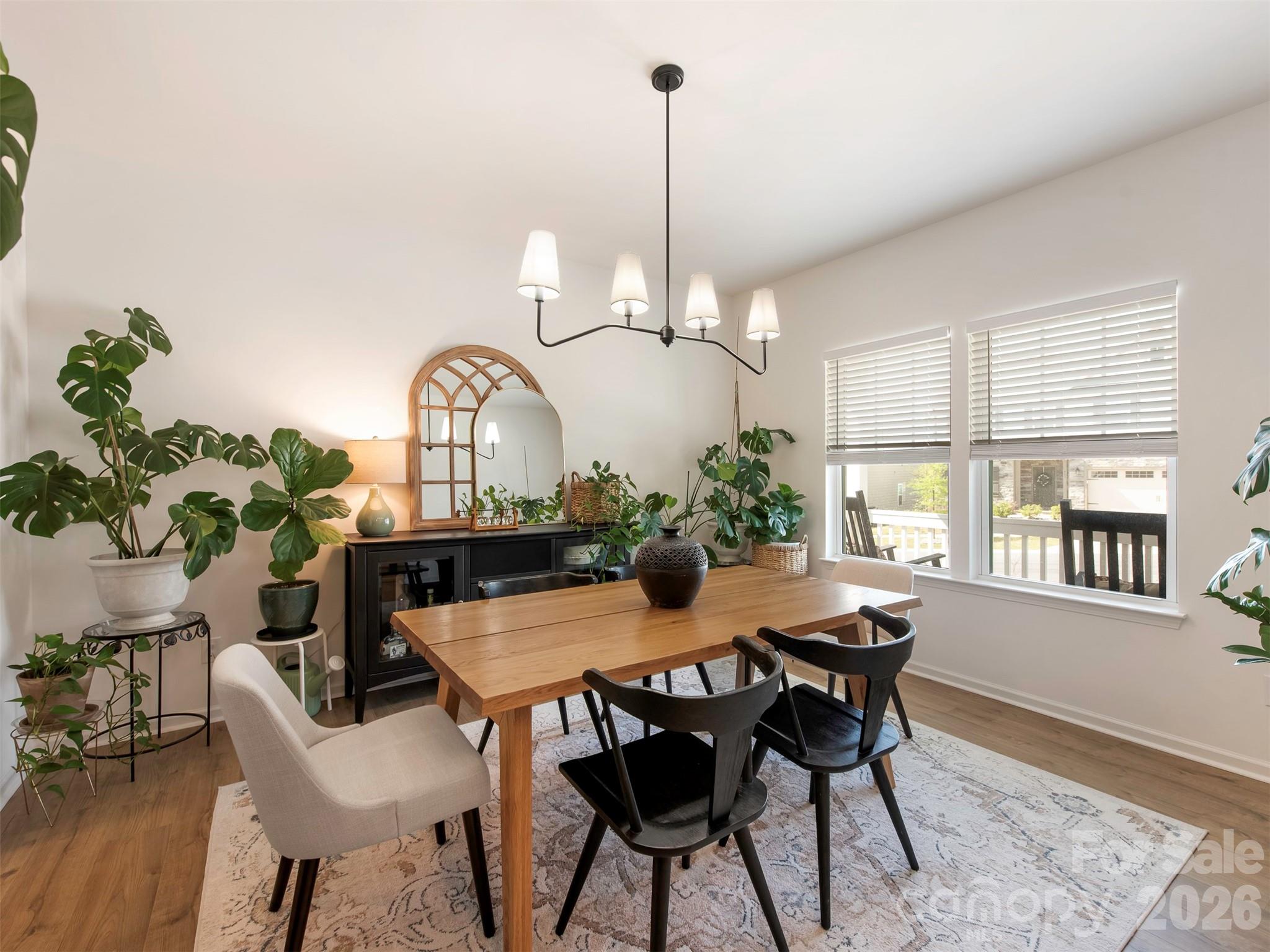 966 Scotch Meadows Loop Monroe, NC 28110 - Photo 9 of 48 a view of a dining room and livingroom with furniture a rug a potted plant and a chandelier