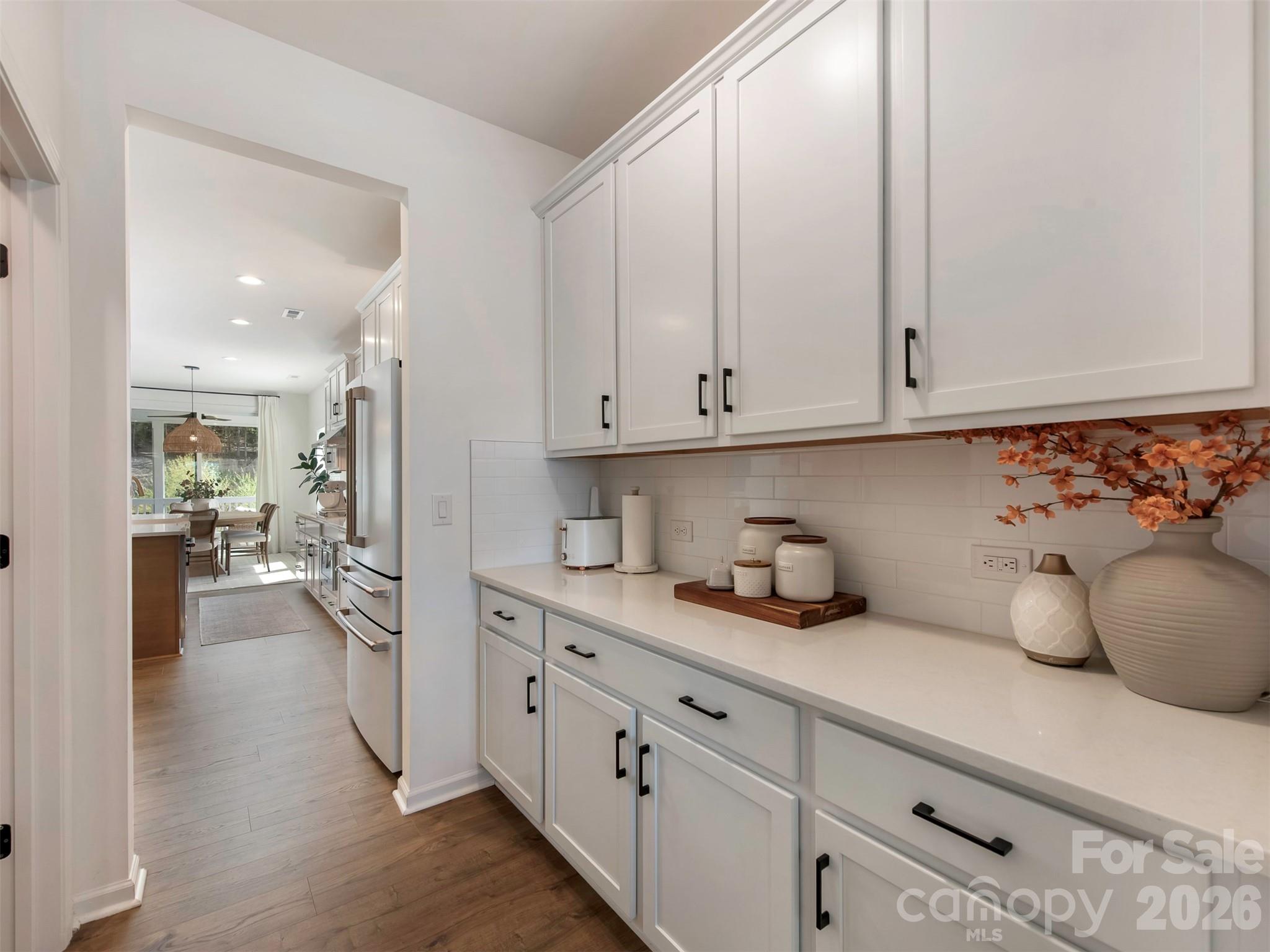 966 Scotch Meadows Loop Monroe, NC 28110 - Photo 10 of 48 a kitchen with white cabinets and sink