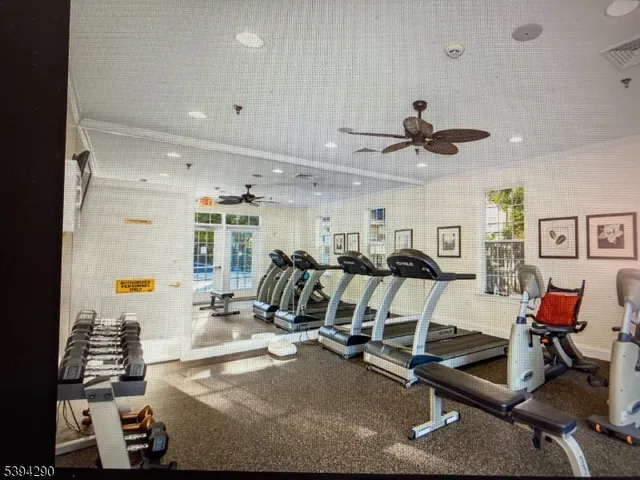 a room with gym equipment and view of gym equipment