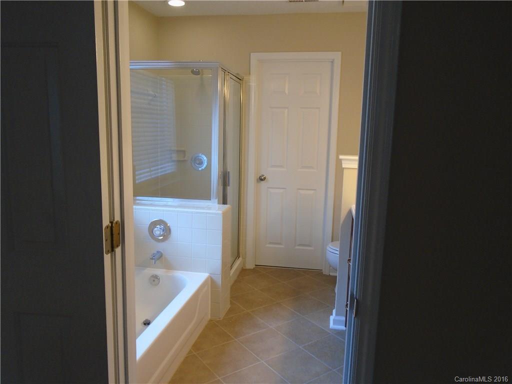 3323 Chistow Road Matthews, NC 28105 - Photo 11 of 12 a bathroom with a tub and shower