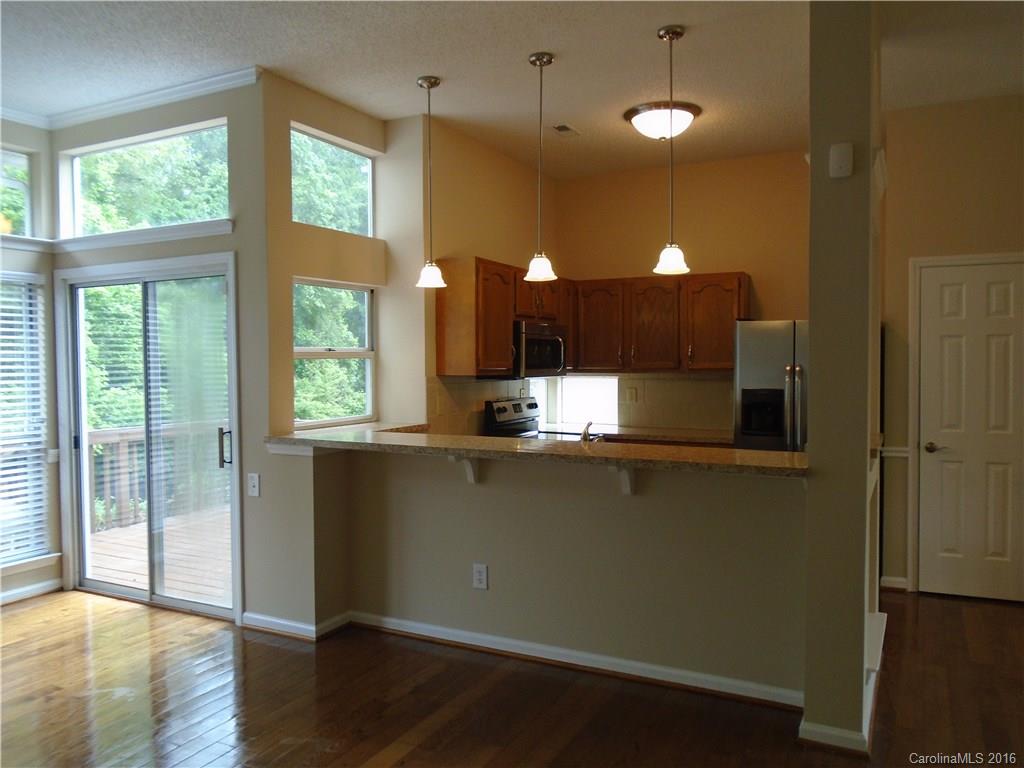 3323 Chistow Road Matthews, NC 28105 - Photo 5 of 12 a view of a kitchen with a window and wooden floor