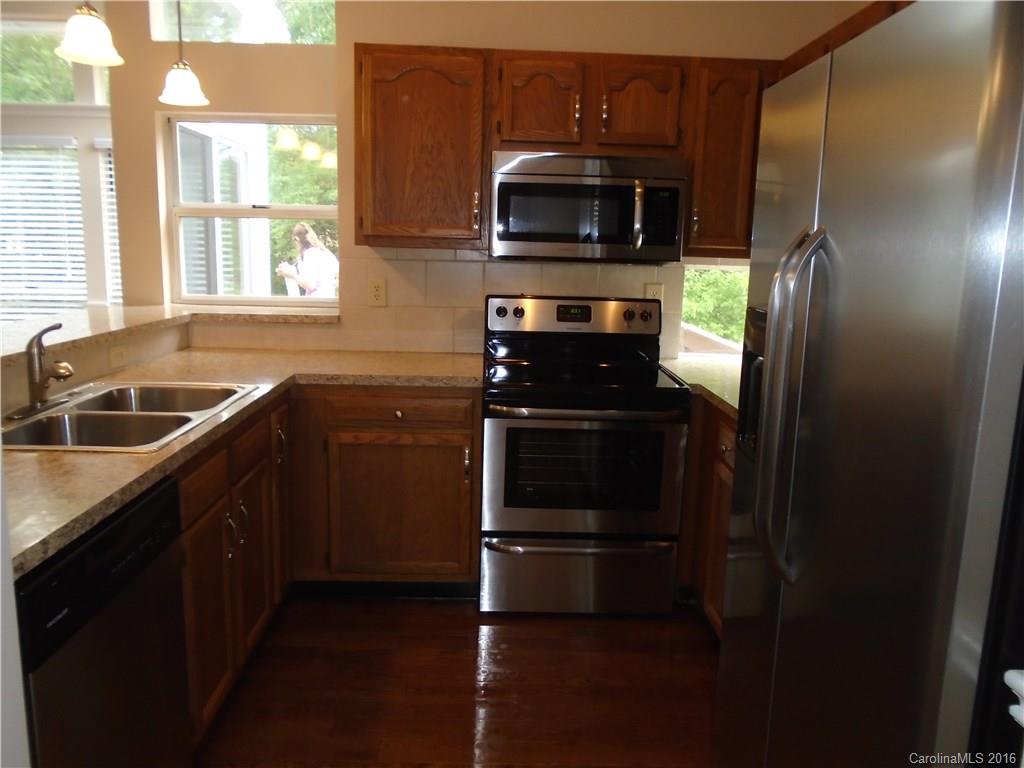 3323 Chistow Road Matthews, NC 28105 - Photo 8 of 12 a kitchen with a sink stove and microwave