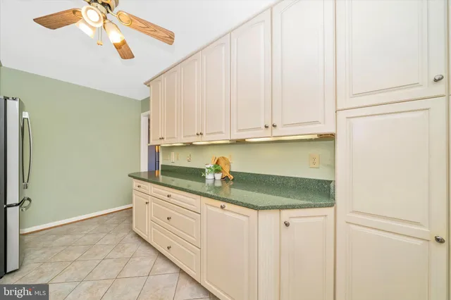 a kitchen with stainless steel appliances granite countertop a refrigerator a stove and a sink with granite countertops