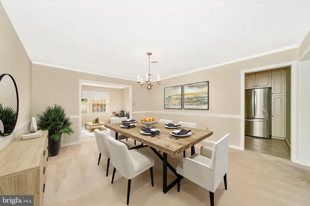 a dining room with furniture window and wooden floor