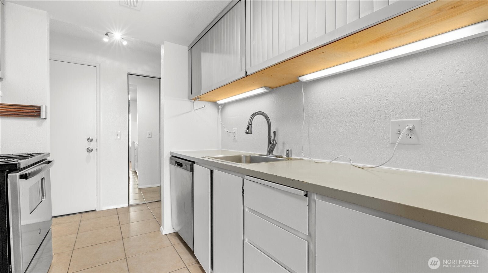 323 75th Street Southeast, Unit B11 Everett, WA 98203 - Photo 11 of 26 a kitchen with a sink and a refrigerator