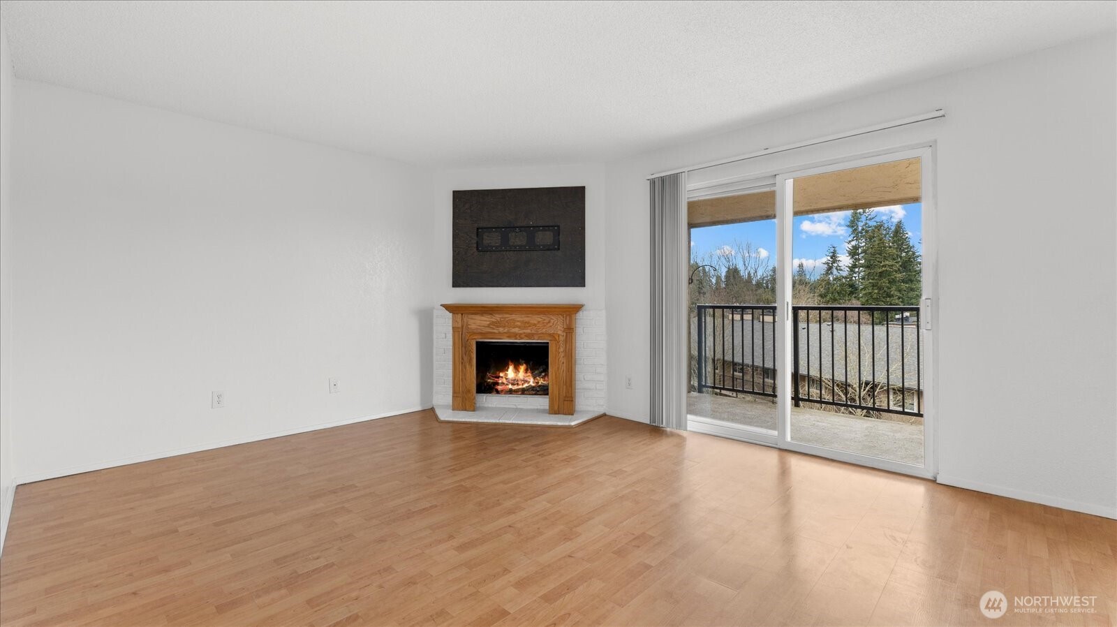 323 75th Street Southeast, Unit B11 Everett, WA 98203 - Photo 14 of 26 a view of empty room with wooden floor and fireplace