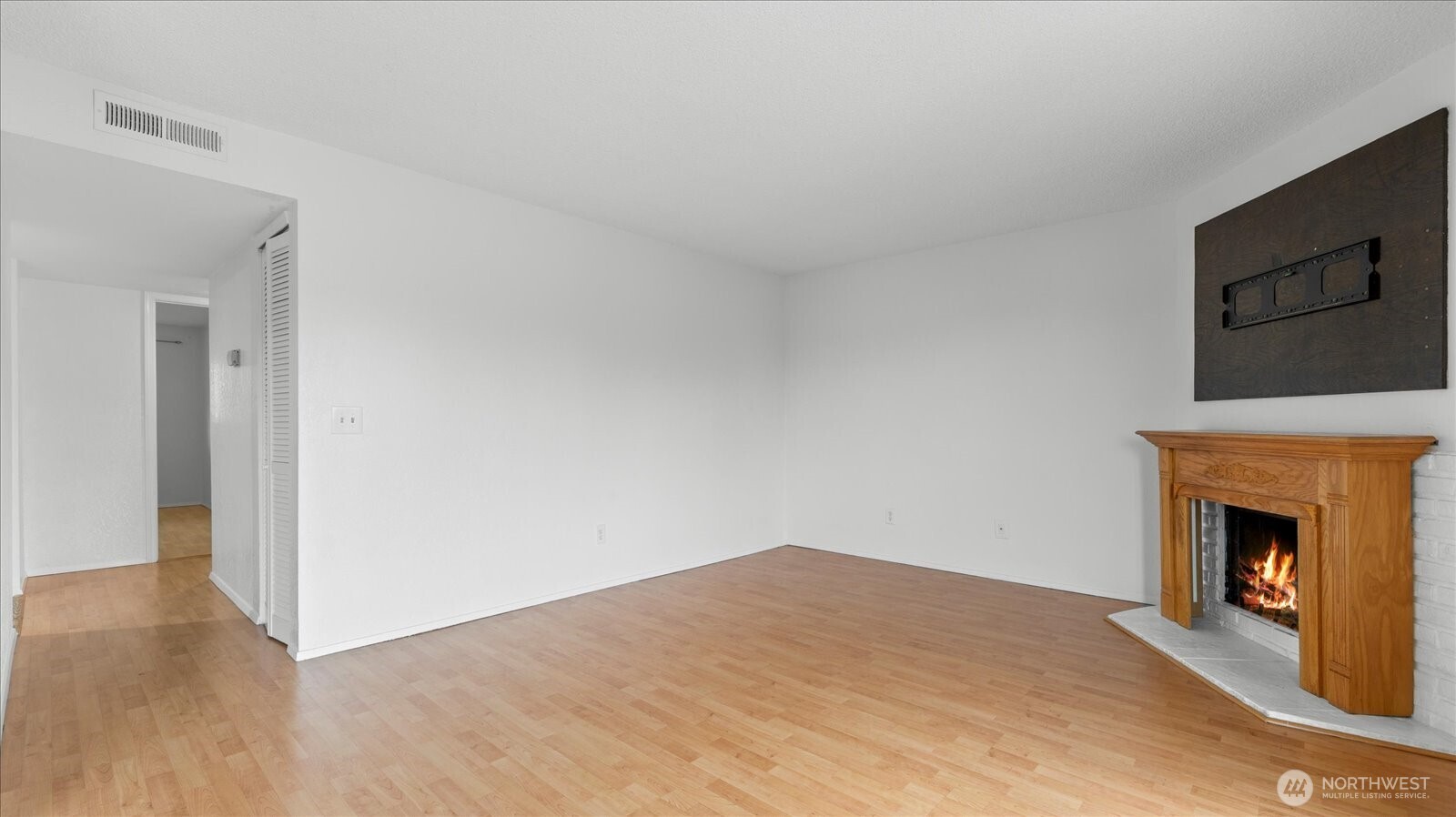 323 75th Street Southeast, Unit B11 Everett, WA 98203 - Photo 17 of 26 a view of empty room with wooden floor and fireplace