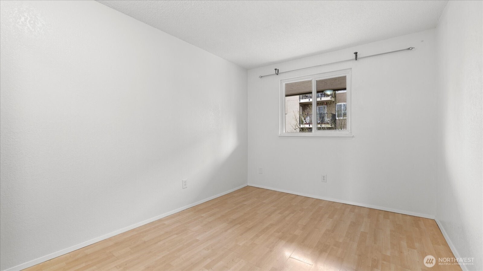 323 75th Street Southeast, Unit B11 Everett, WA 98203 - Photo 20 of 26 a view of a big room with wooden floor and windows