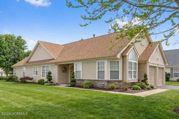 a front view of a house with a yard and porch