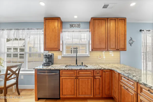 a large kitchen with a table and chairs in it