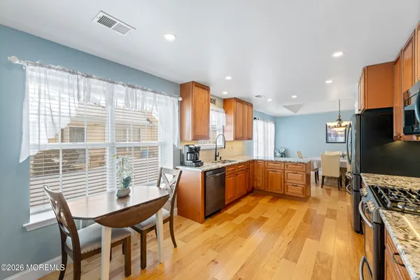 a view of a livingroom with furniture hardwood floor and a large window