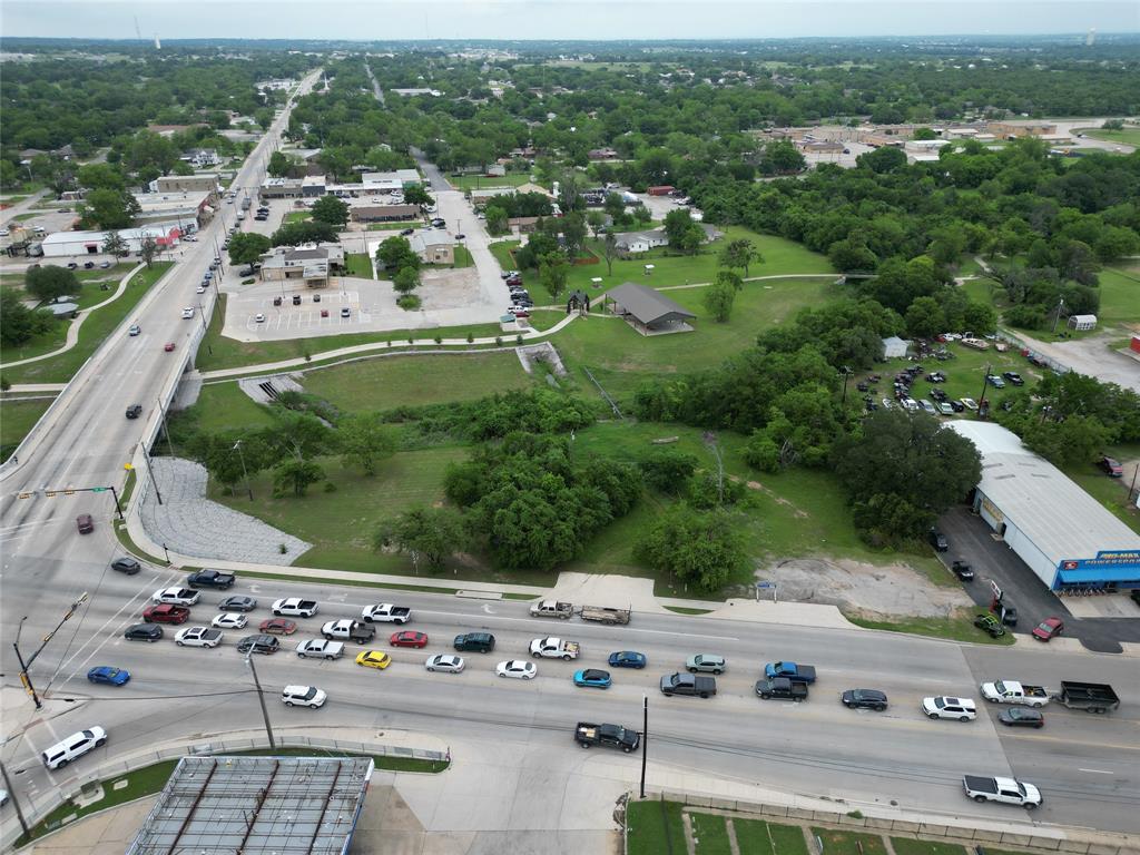 116 East Highway 199 Springtown, TX 76082 - Photo 5 of 15 Aerial perspective showcasing a multi-lane roadway and overpass, surrounded by mature trees and commercial structures