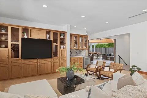 a living room with furniture and a mirror