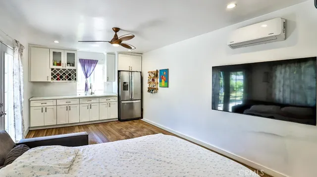 a view of a house with potted plants and large trees