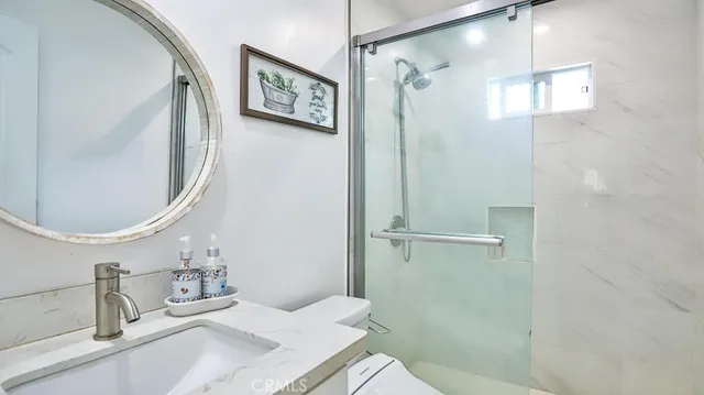 a view of a patio with plants and chairs under an umbrella