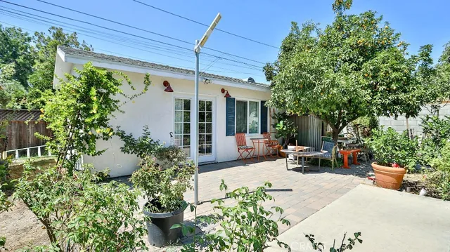 a view of a patio with table and chairs and potted plants