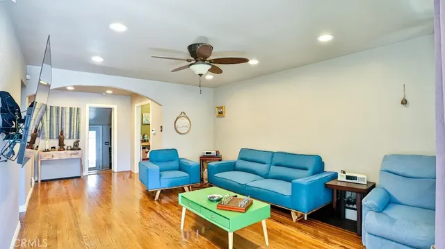 a living room with furniture and a chandelier