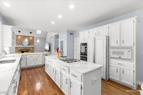 a kitchen with white cabinets and stainless steel appliances
