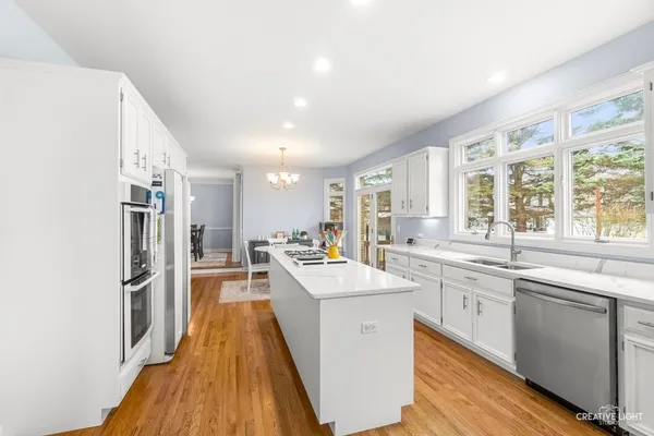 a kitchen with a sink stove and refrigerator