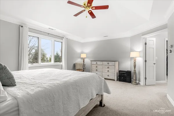 a spacious bedroom with a large bed and a window