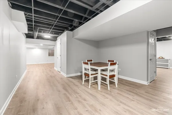 a dining room with furniture and wooden floor