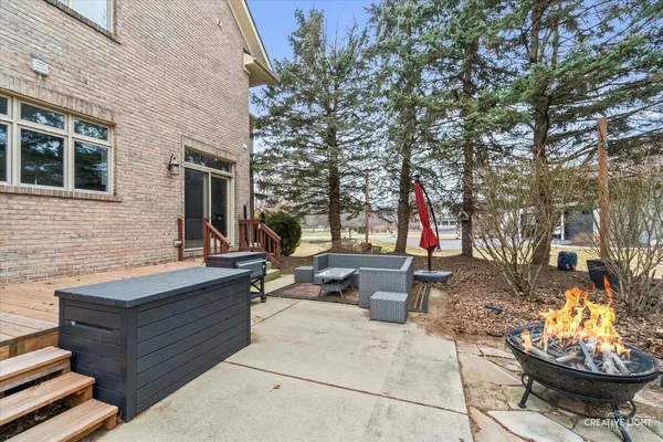 a view of a backyard with sitting area and fire pit