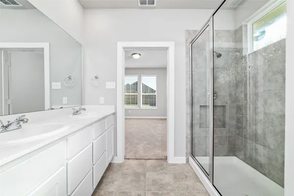 a bathroom with a shower sink and mirror