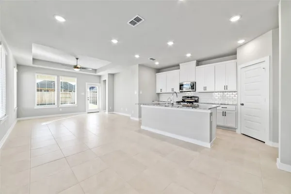 a kitchen with white cabinets and white appliances