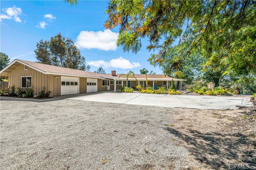 39980 Vía Fernando Temecula, CA 92592 - Photo 2 of 73 a front view of house with yard and trees in the background