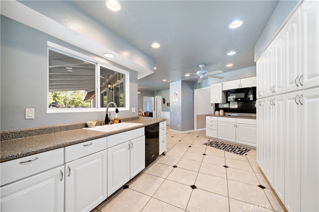 39980 Vía Fernando Temecula, CA 92592 - Photo 23 of 73 a large white kitchen with center island and stainless steel appliances