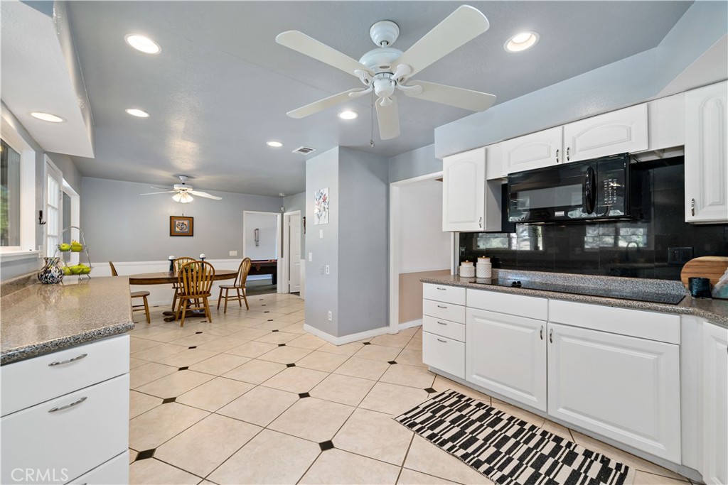 39980 Vía Fernando Temecula, CA 92592 - Photo 24 of 73 a kitchen with stainless steel appliances kitchen island granite countertop a sink and cabinets