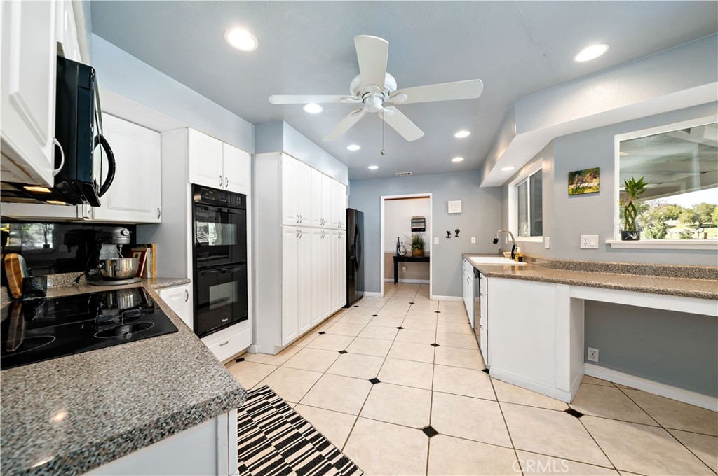 39980 Vía Fernando Temecula, CA 92592 - Photo 25 of 73 a large kitchen with stainless steel appliances kitchen island granite countertop a refrigerator and microwave