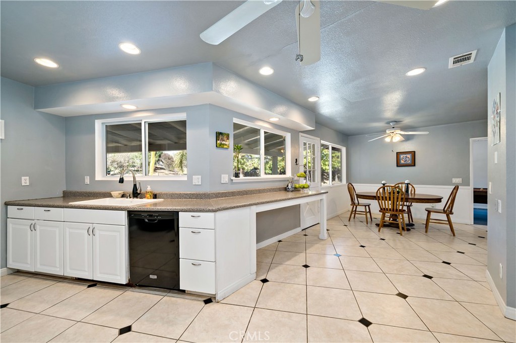 39980 Vía Fernando Temecula, CA 92592 - Photo 26 of 73 a kitchen with stainless steel appliances kitchen island granite countertop a sink and cabinets