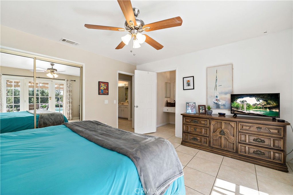 39980 Vía Fernando Temecula, CA 92592 - Photo 38 of 73 a spacious bedroom with a large bed and a flat screen tv