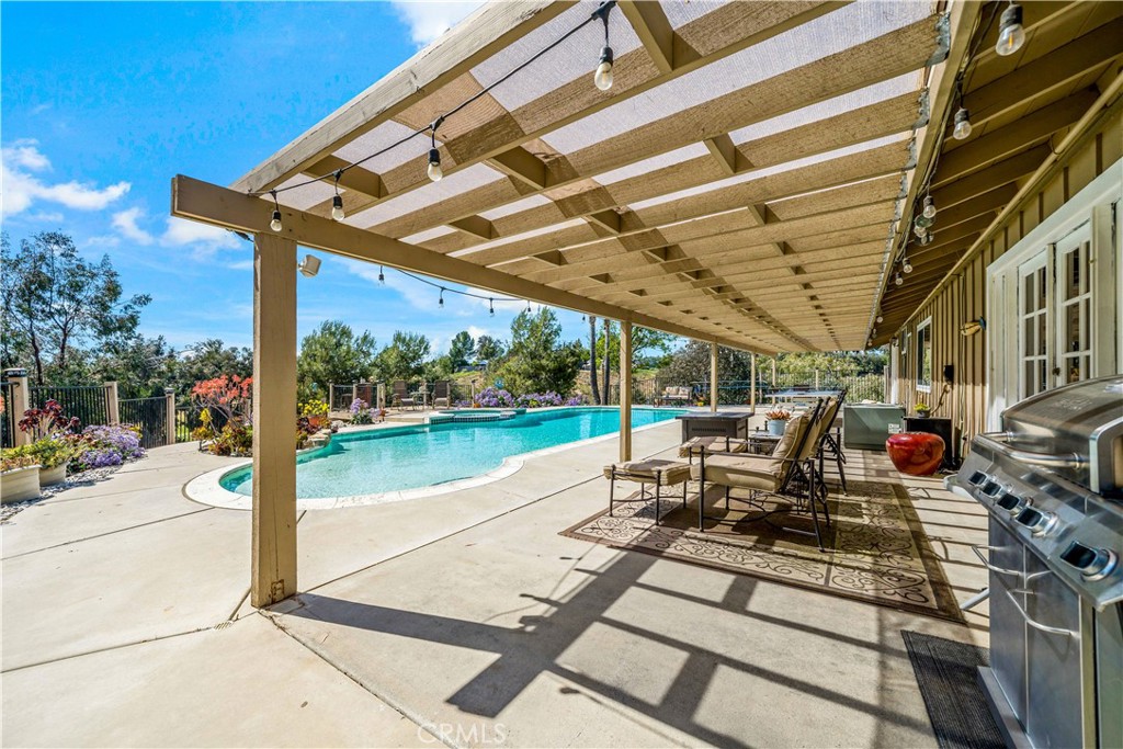 39980 Vía Fernando Temecula, CA 92592 - Photo 40 of 73 a view of a patio with a table and chairs next to a yard