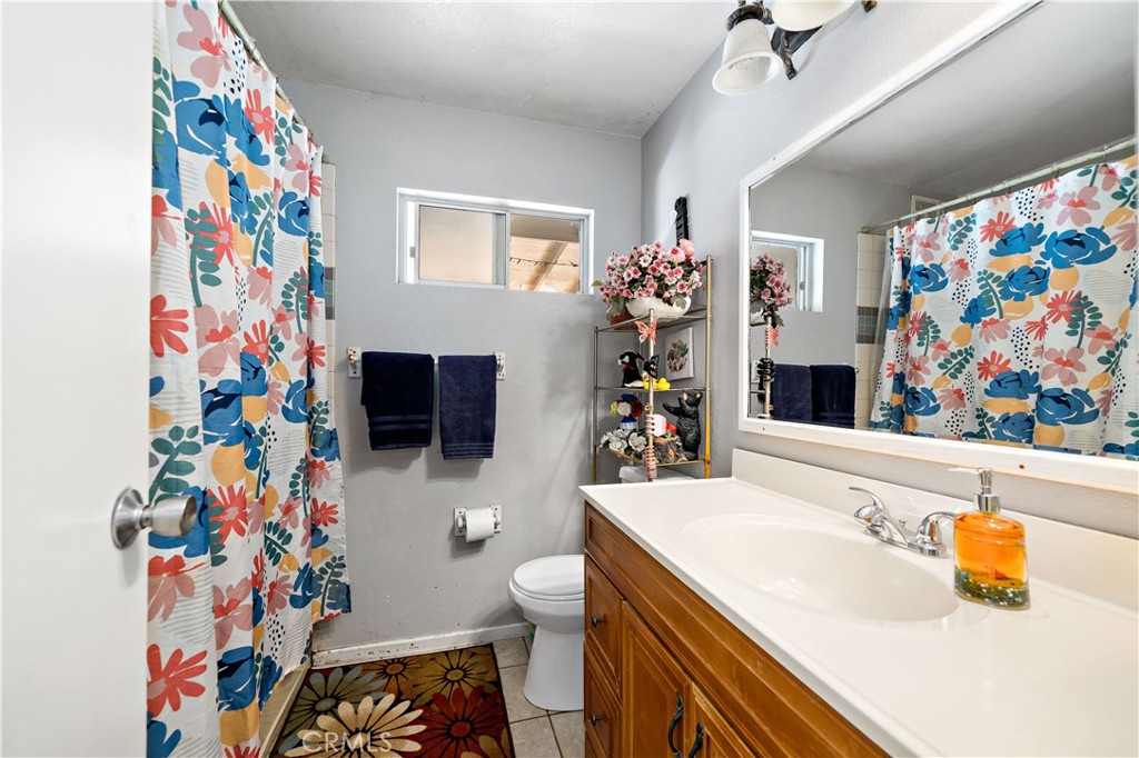 39980 Vía Fernando Temecula, CA 92592 - Photo 52 of 73 a bathroom with a sink a toilet and a shower curtain