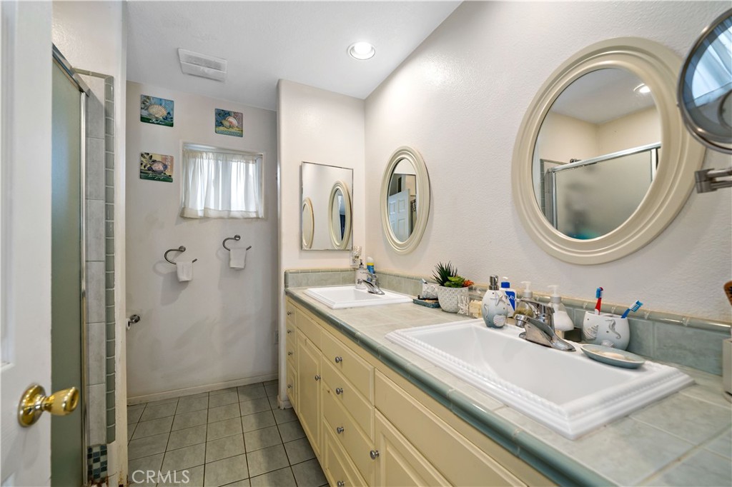 39980 Vía Fernando Temecula, CA 92592 - Photo 64 of 73 a bathroom with a granite countertop sink mirror and vanity